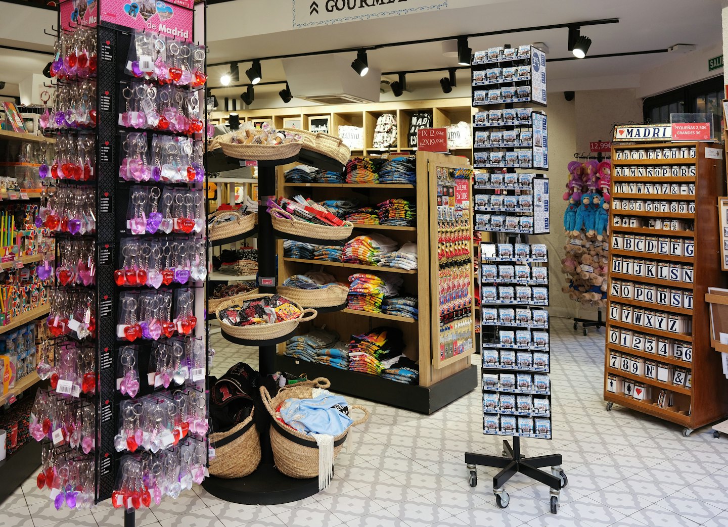 Merchandise displayed on racks and shelves in a souvenir shop.